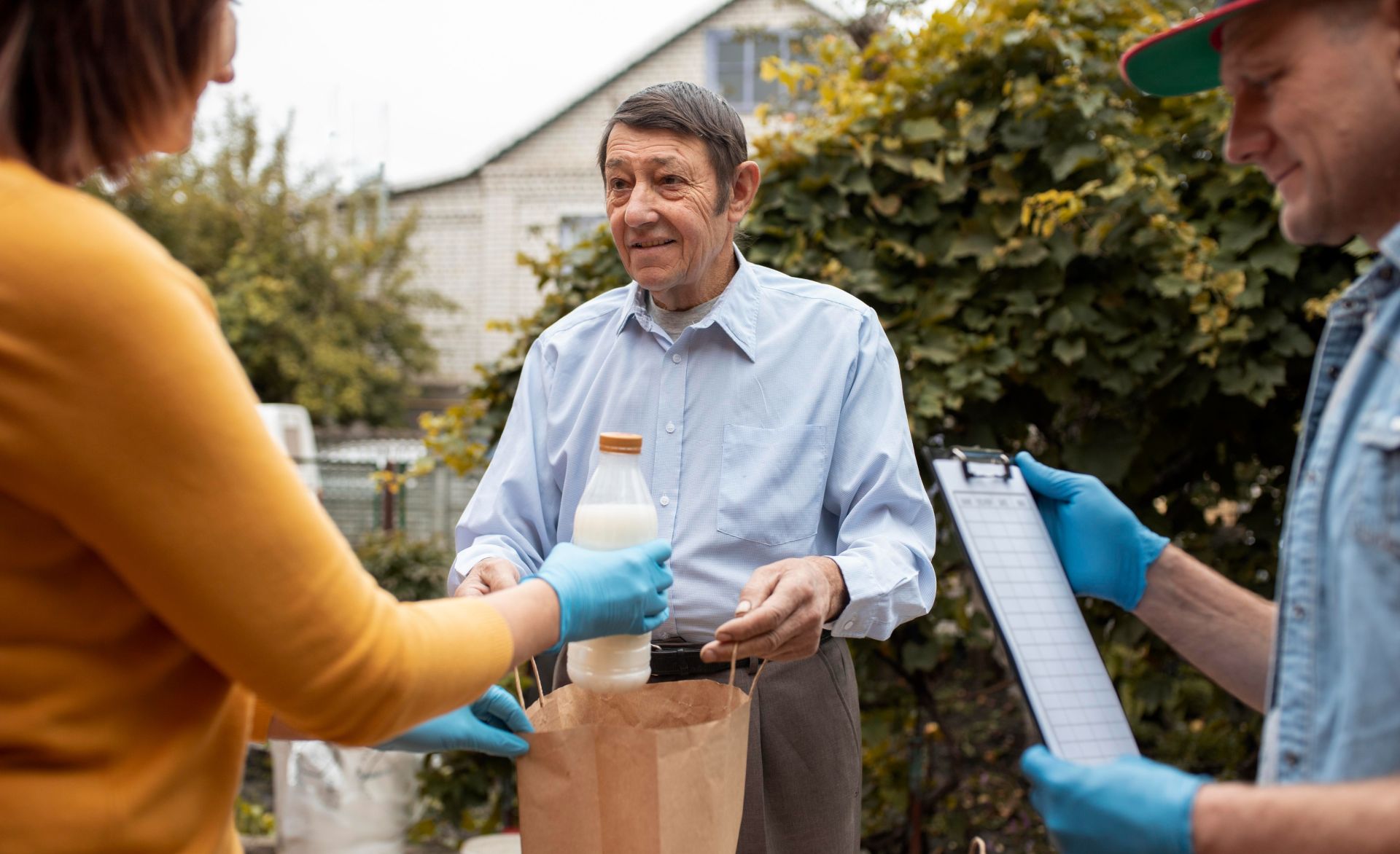 Volunteers organize and load boxes of donated supplies into a van for distribution.